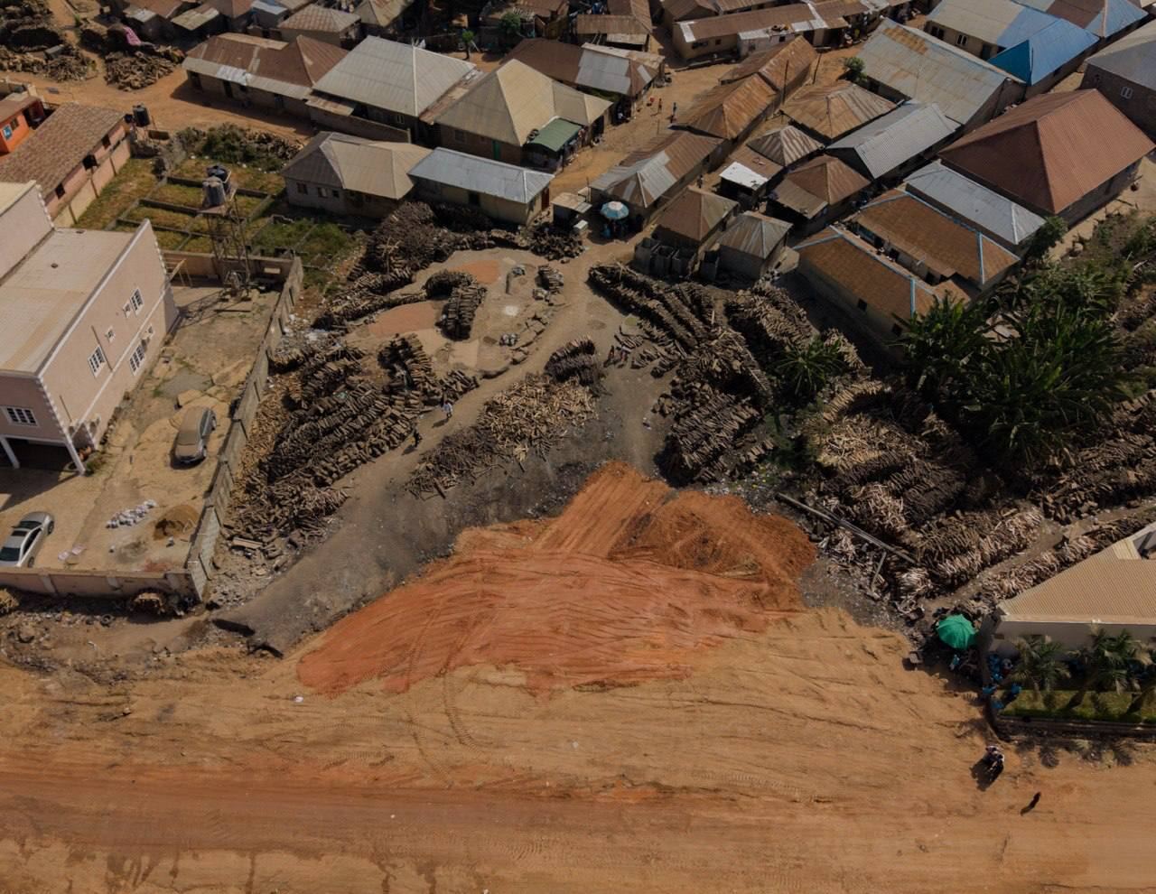 From above: the same plot cleared to bare orange ground, the same house at top left
